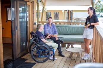 Friends gathering together on the Safari Tent Deck at Sails Holiday Park.